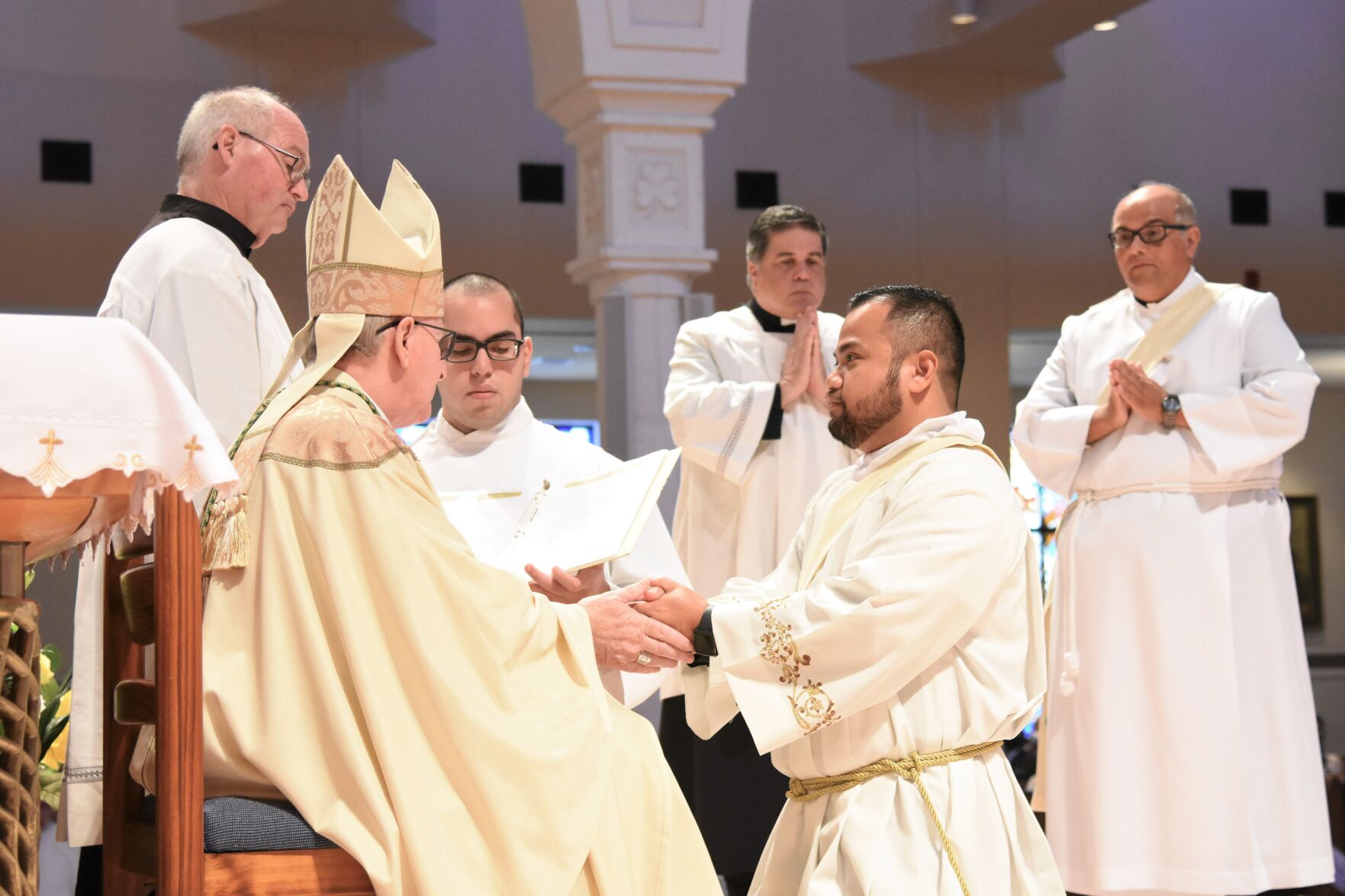 Bishop John Noonan anoints the hands of Father Nathanael Soliven.
